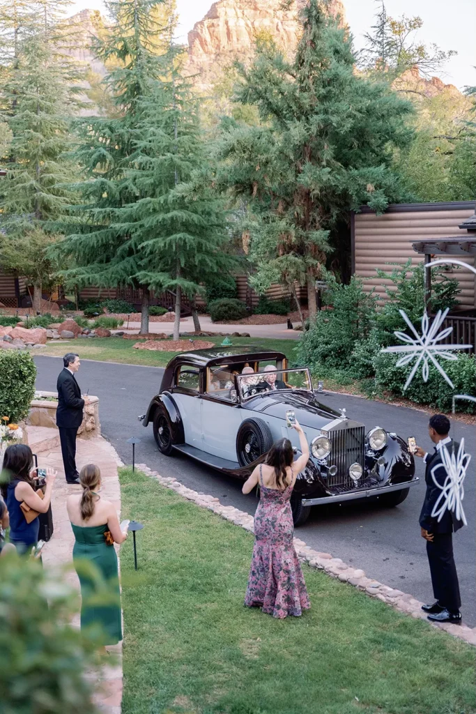 wedding guests photographing antique car