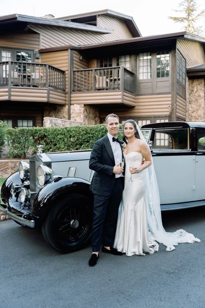 bride and groom with rolls Royce behind them