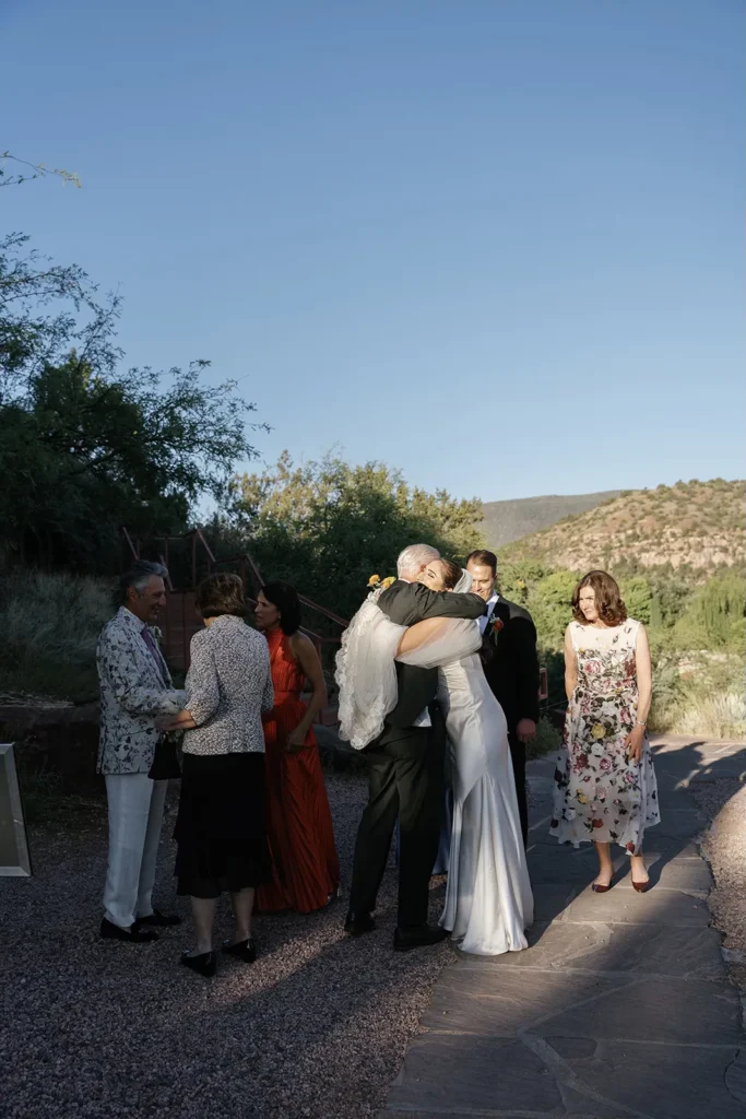 family congratulating couple after marriage