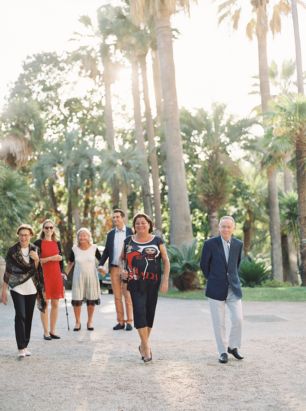 Wedding guests arriving through palm-lined gardens at Villa Durazzo in Santa Margherita Ligure
