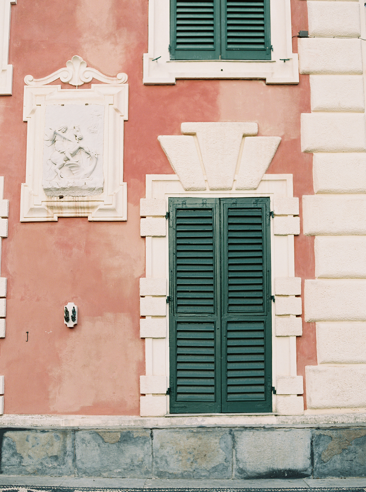 Pink historic villa façade with green shutters at Villa Durazzo, Santa Margherita Ligure