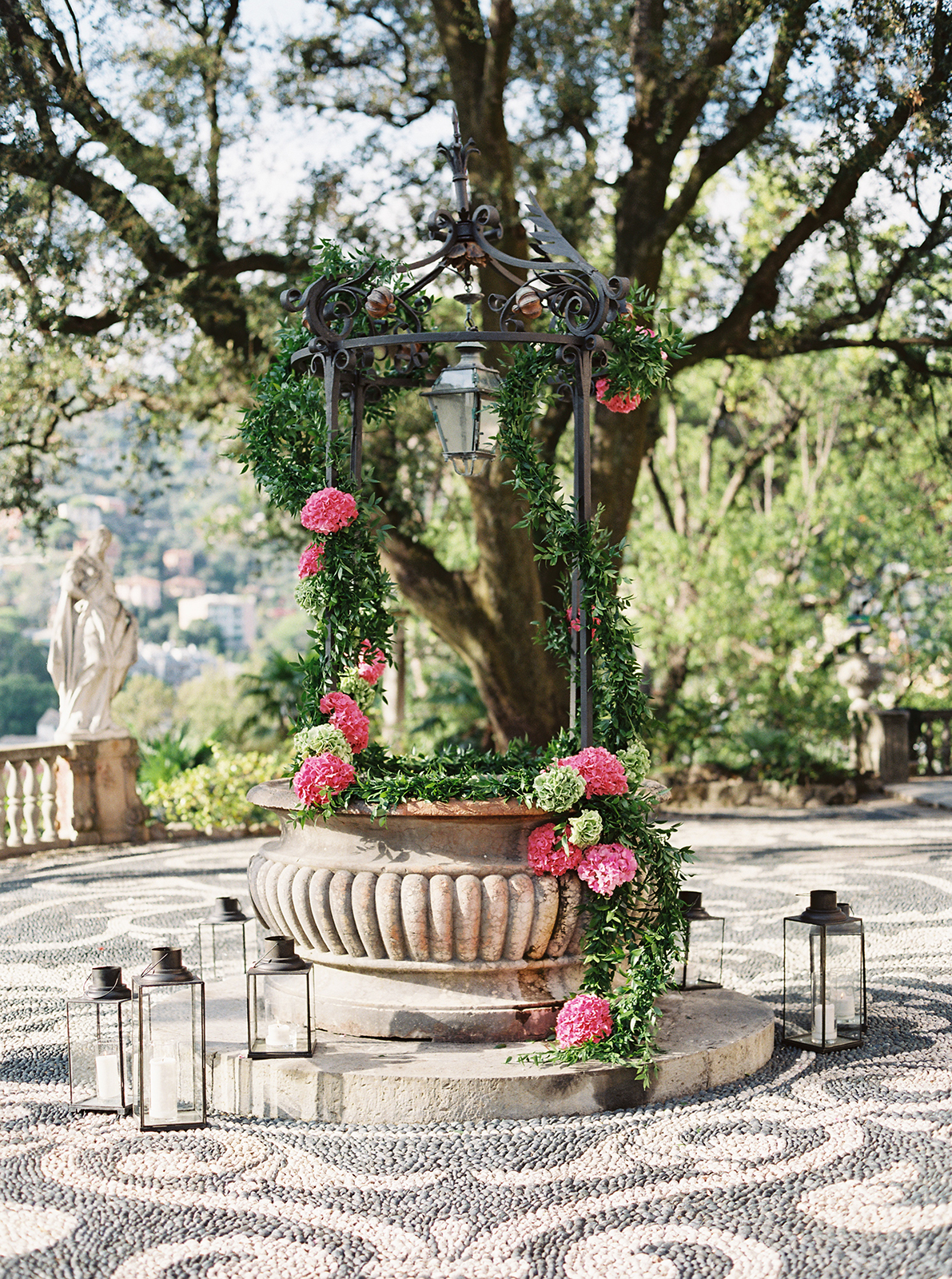Ceremony well decorated with pink hydrangeas and greenery at Villa Durazzo wedding venue