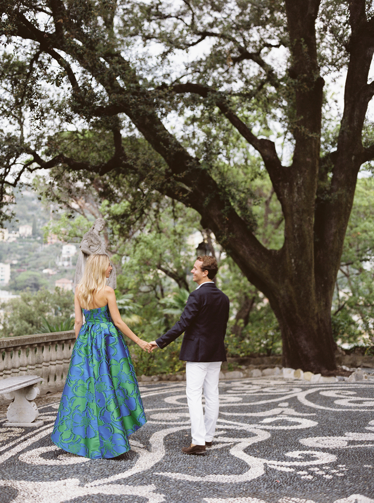Couple walking hand in hand through the gardens of Villa Durazzo in Santa Margherita Ligure