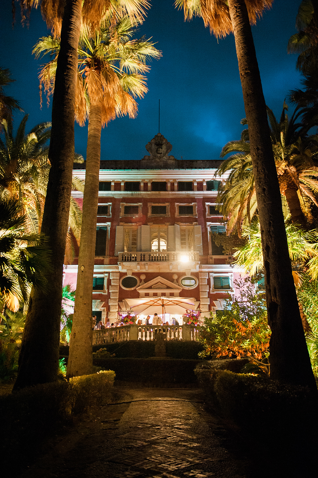Elegant exterior view of a Villa Durazzo glowing at night during a wedding celebration