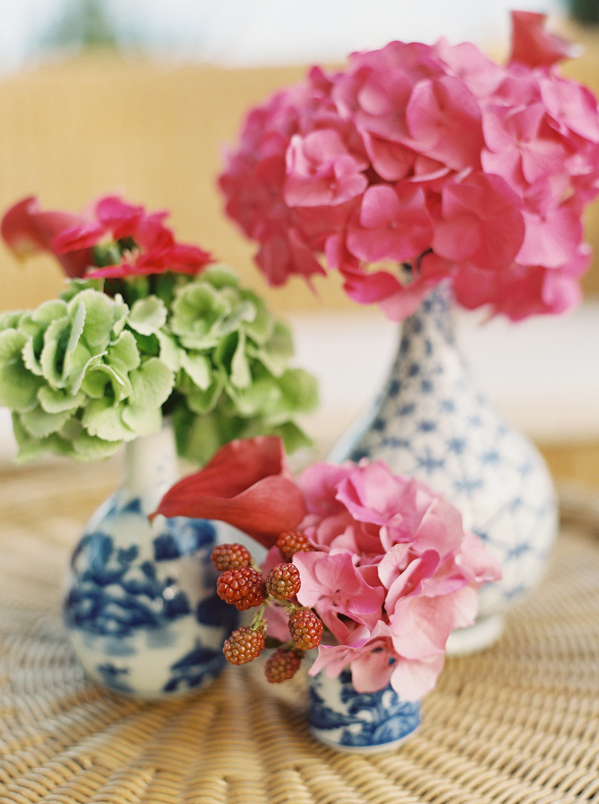 Blue and white ceramic vases with pink and green floral arrangements at Villa Durazzo wedding
