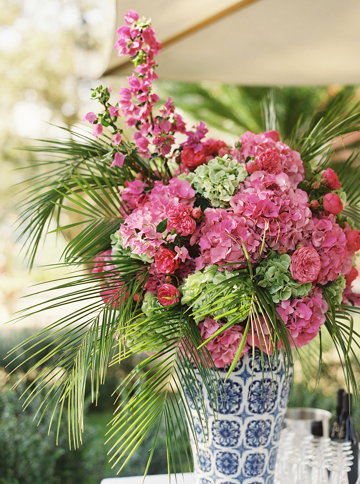 Blue and white ceramic vases with pink and green floral arrangements at Villa Durazzo wedding