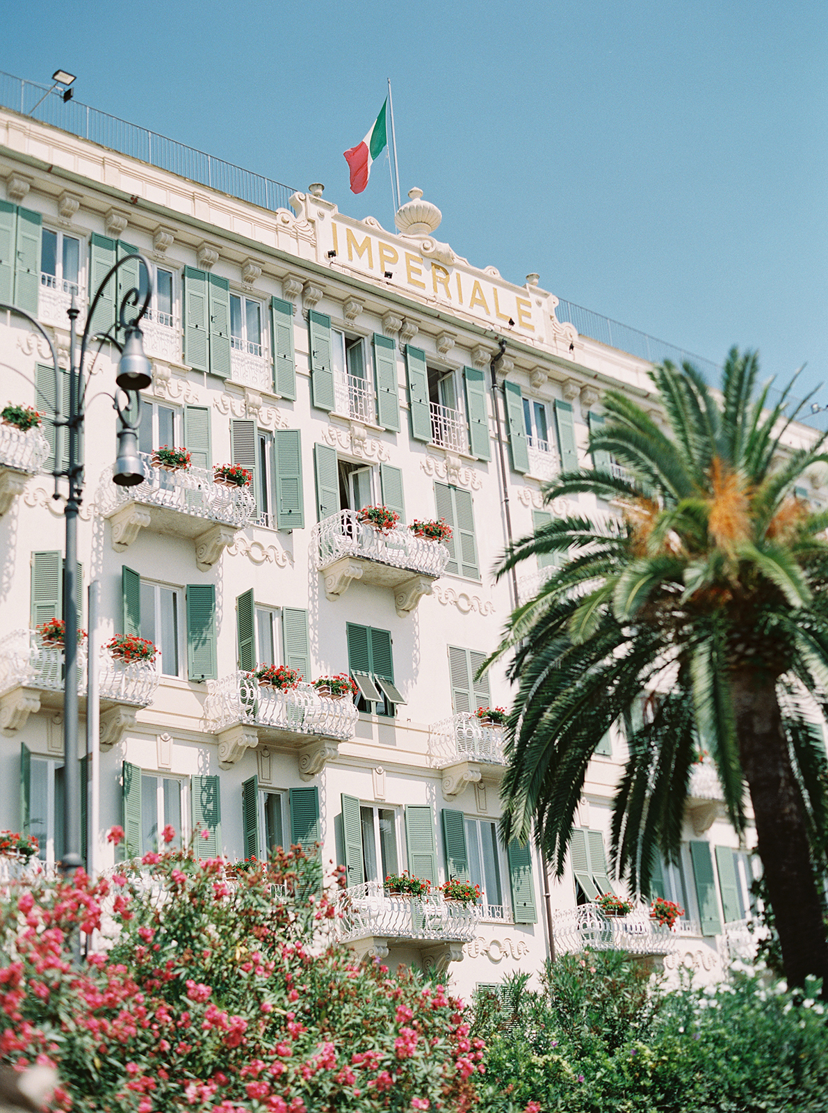 Exterior of Imperiale Palace Hotel in Portofino with classic Italian architecture and palm trees