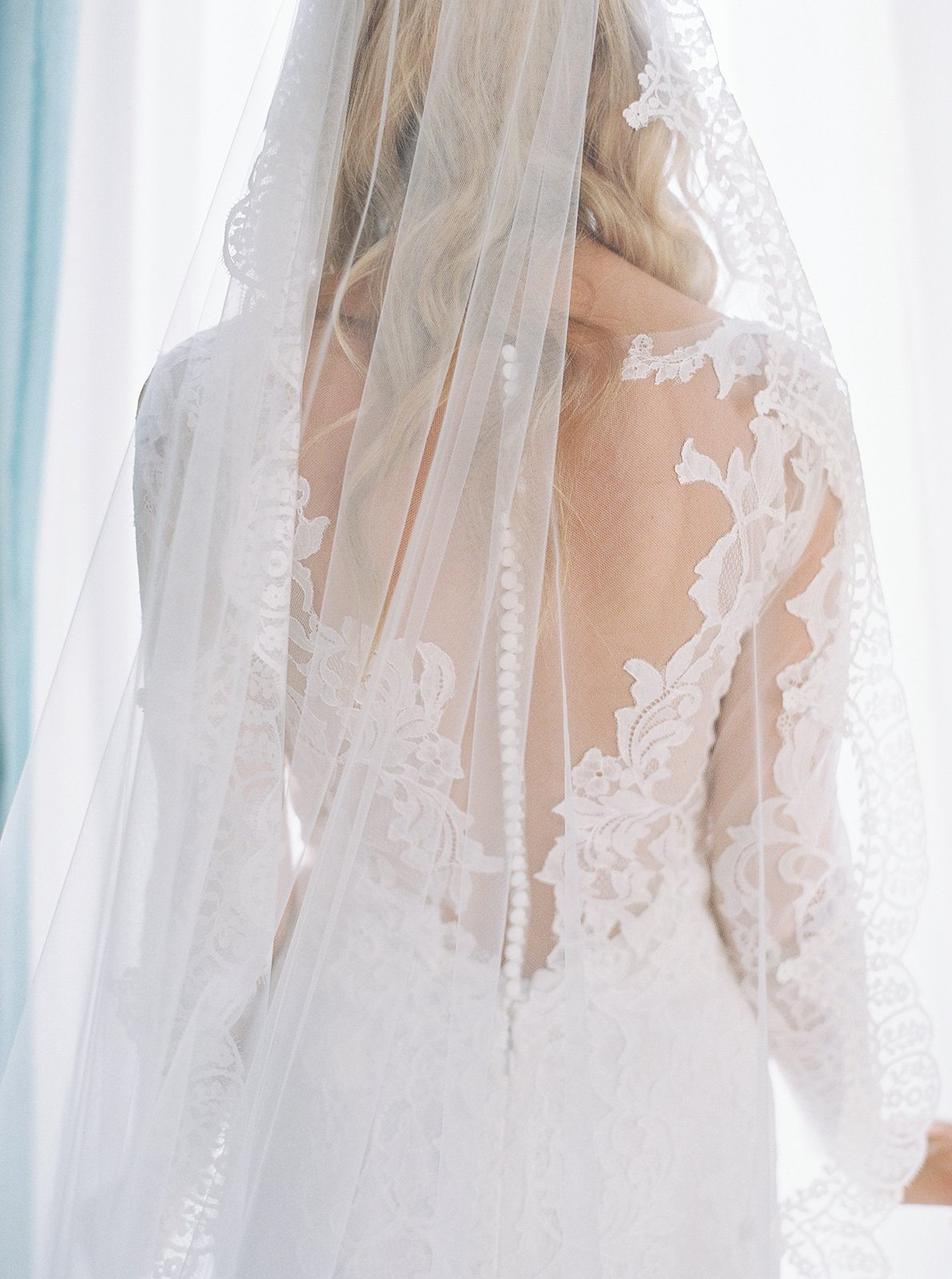 Close-up of lace wedding dress and veil during bridal preparations at Imperiale Palace Hotel in Portofino