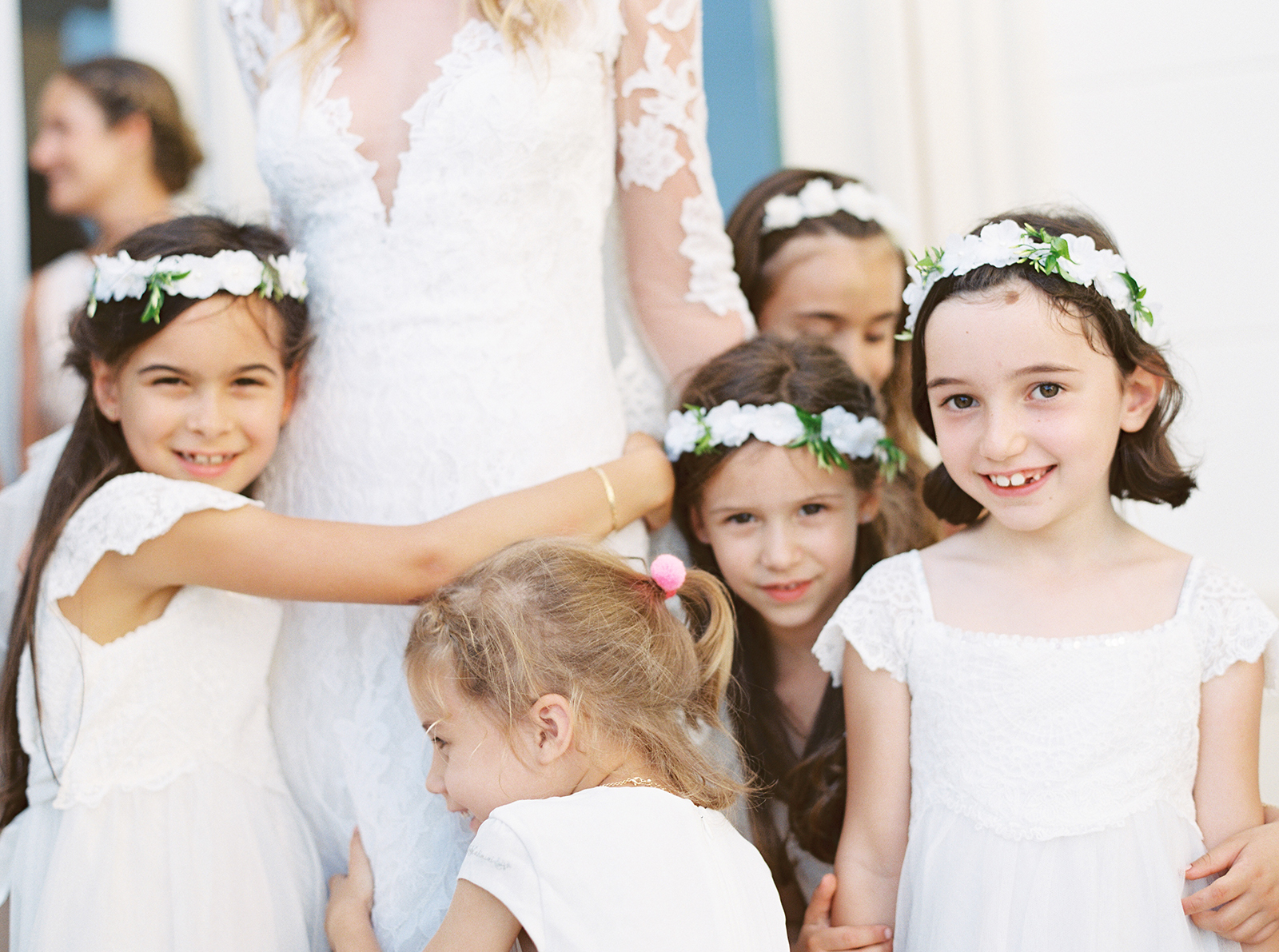 Flower girls hugging the bride during wedding preparations at Imperiale Palace Hotel in Portofino