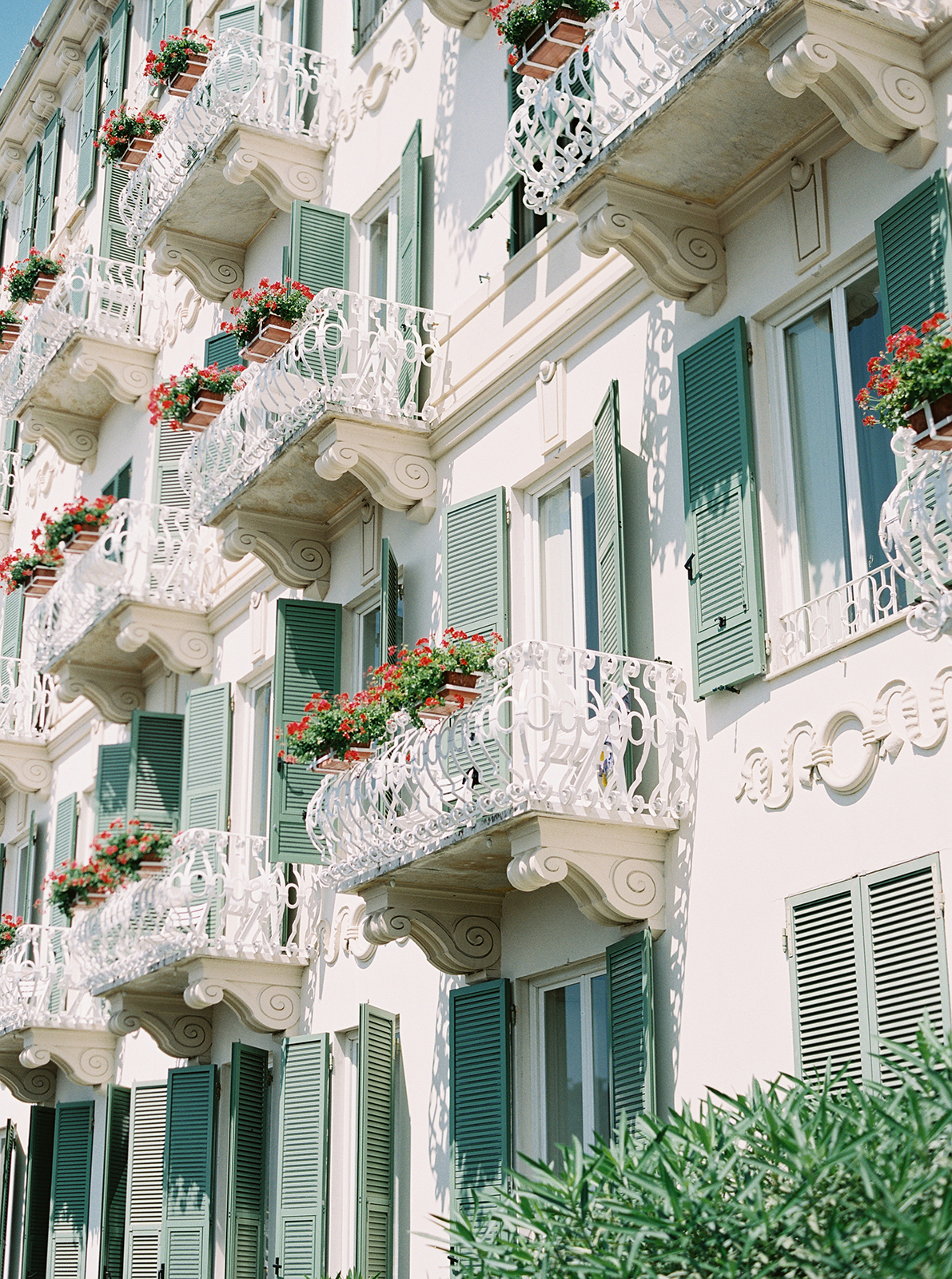 Elegant balconies and shutters at Imperiale Palace Hotel in Portofino captured on a sunny day