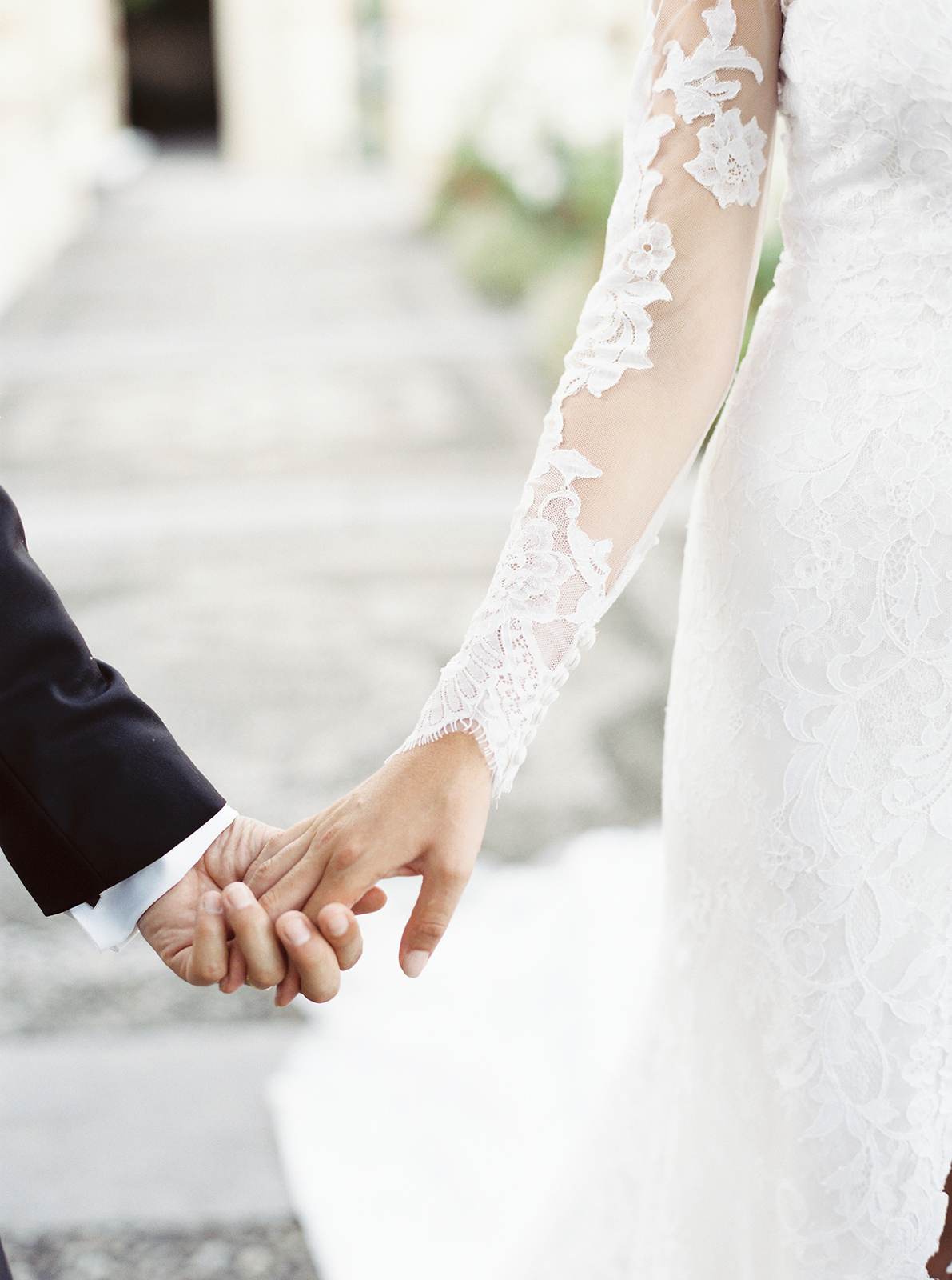 Bride and groom holding hands in an intimate detail shot at La Cervara wedding in Portofino