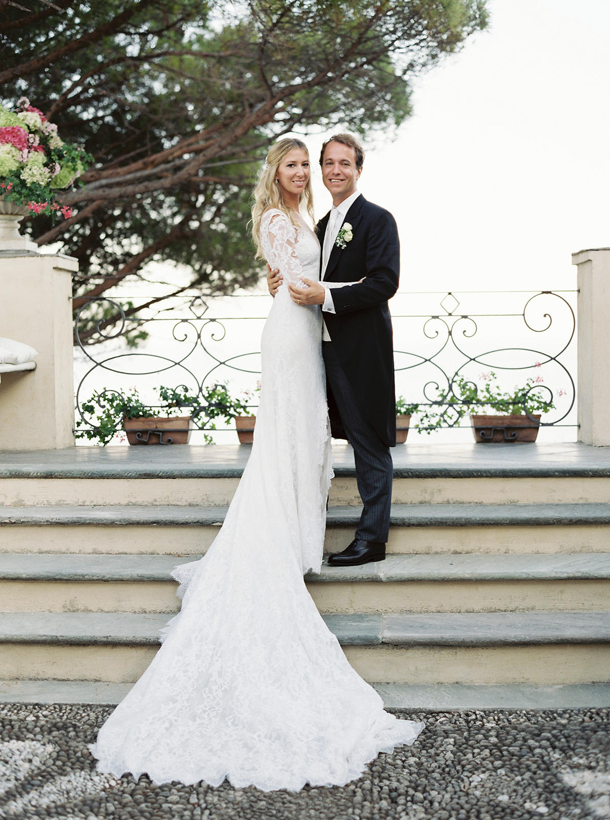 Elegant bride and groom portrait on the stone steps at La Cervara Abbey in Portofino