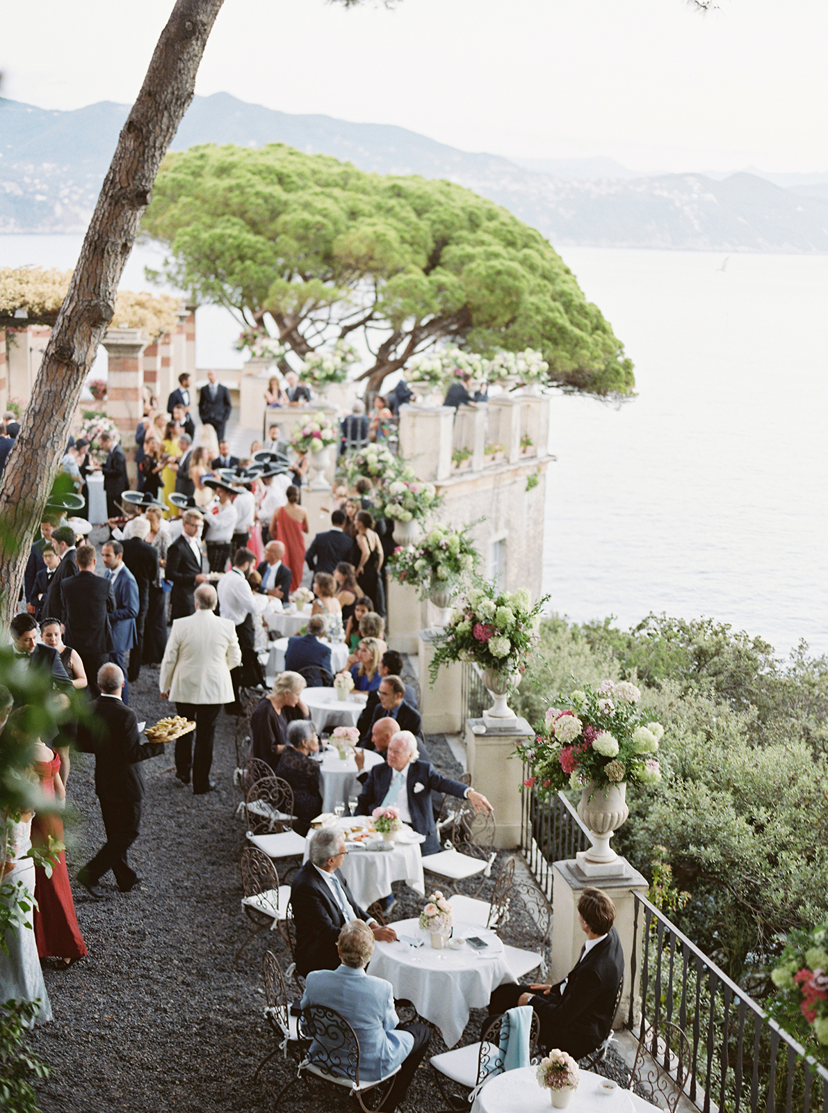 Elegant outdoor wedding reception at La Cervara in Portofino, featuring intimate tables set along the cliffside terrace