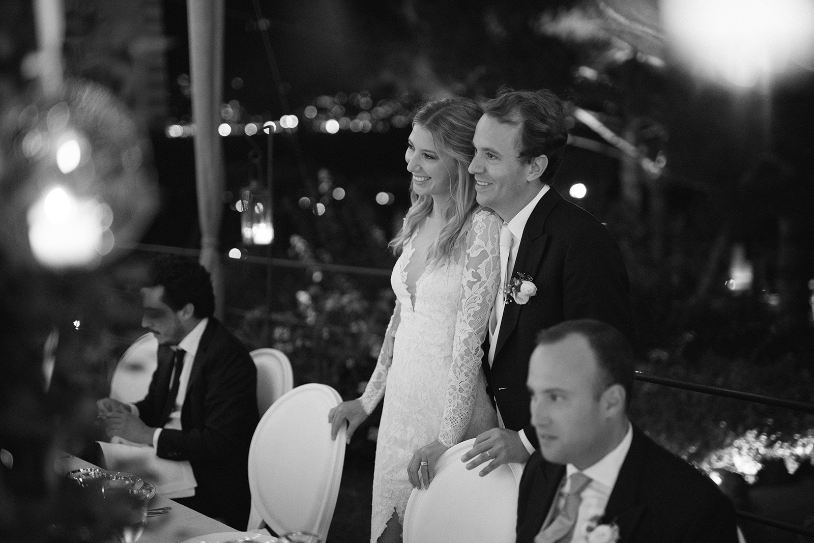 Black and white portrait of bride and groom smiling together during an intimate wedding reception