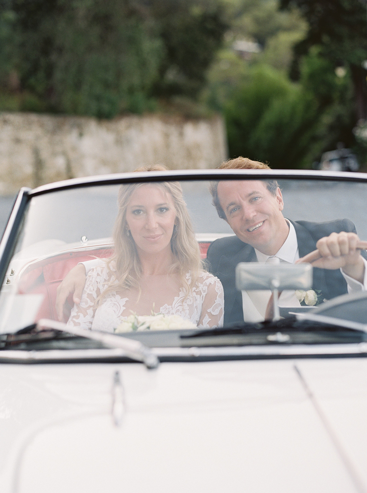 Bride and groom riding in vintage convertible at La Cervara Abbey wedding in Portofino