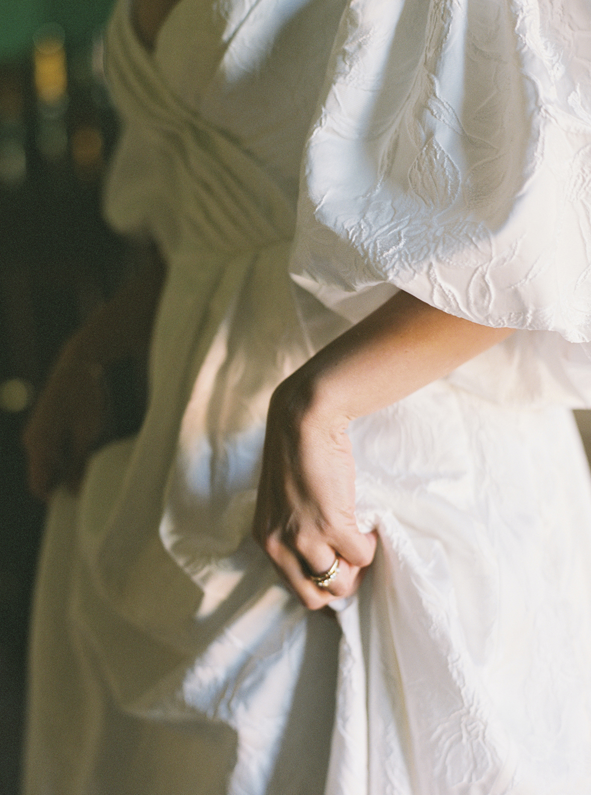 Bride holding wedding dress fabric during ceremony at Casa de Sierra Nevada