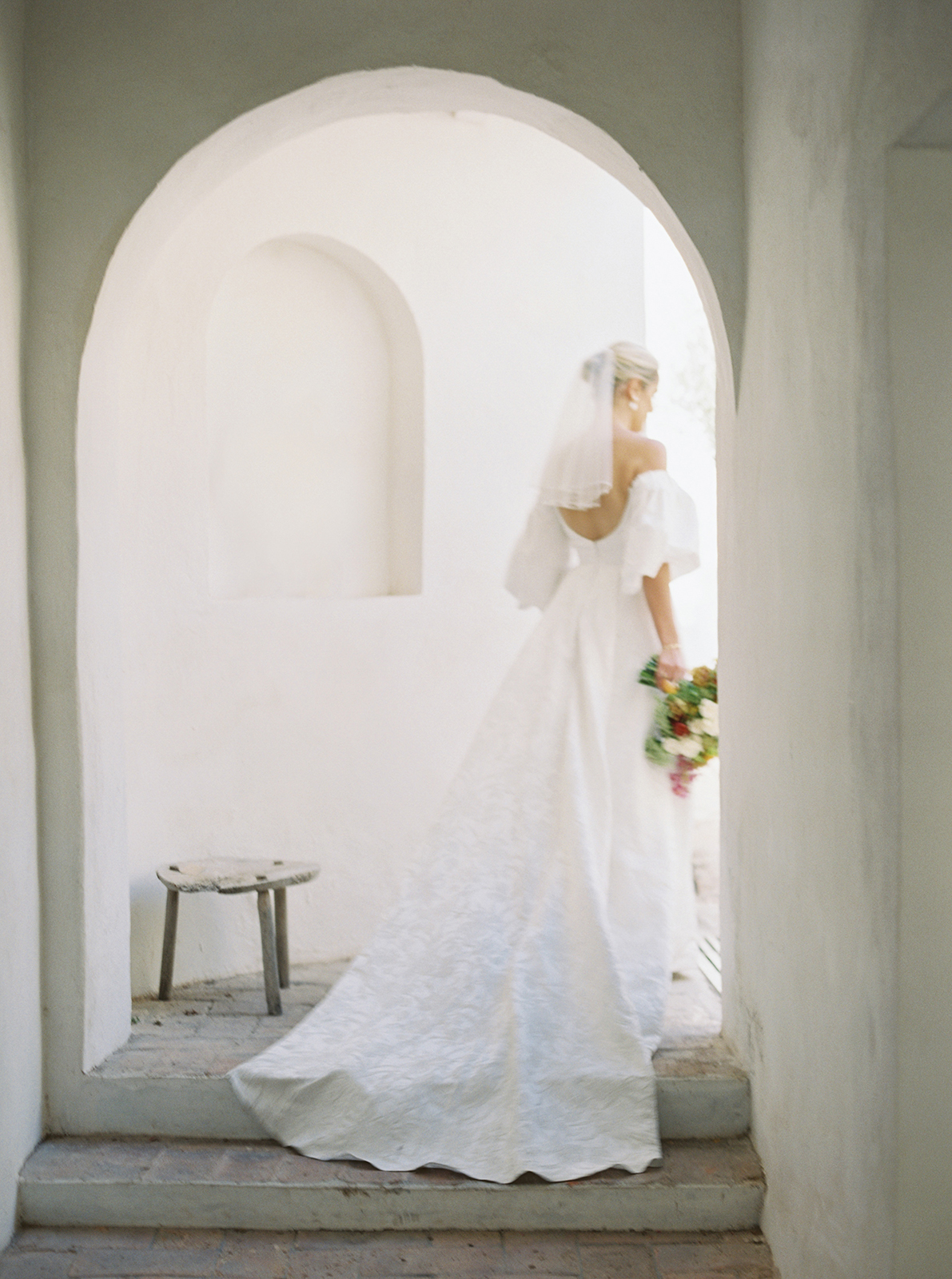 Bride walking through archway at Casa de Sierra Nevada Belmond Hotel