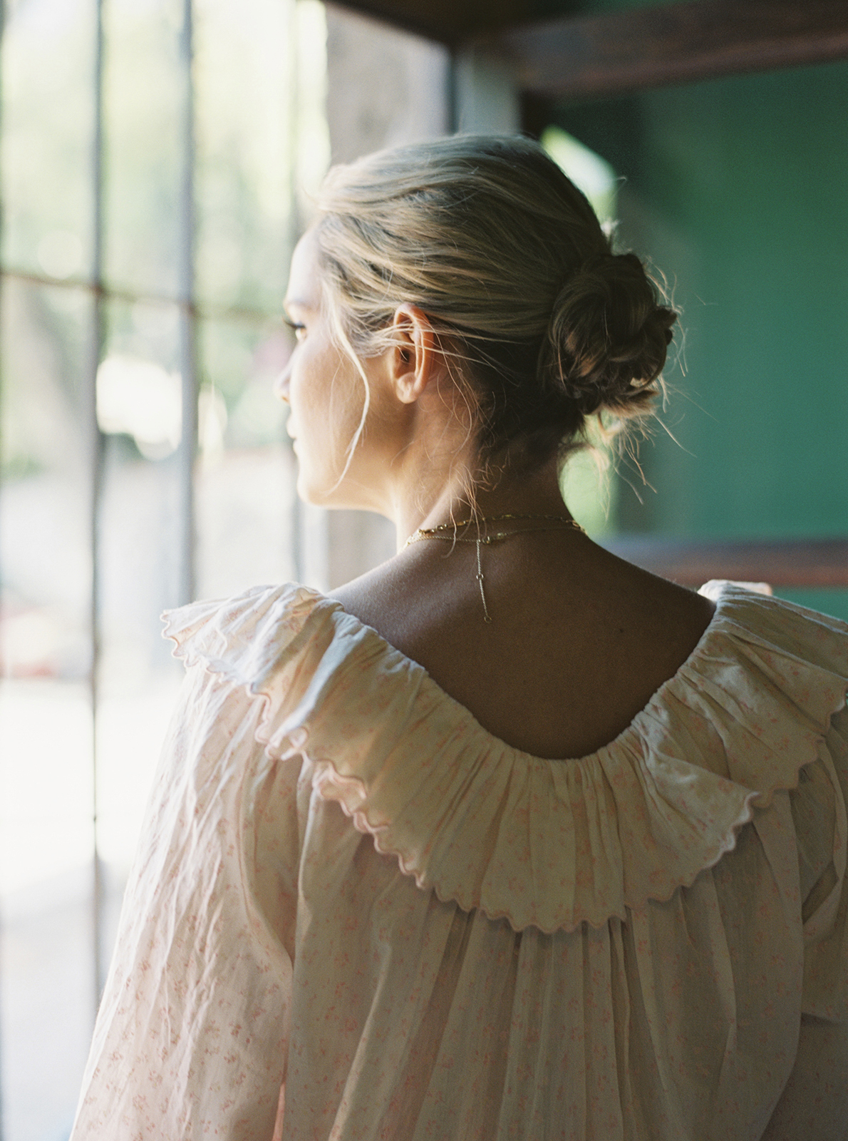 Bride getting ready by window at Casa de Sierra Nevada Belmond Hotel