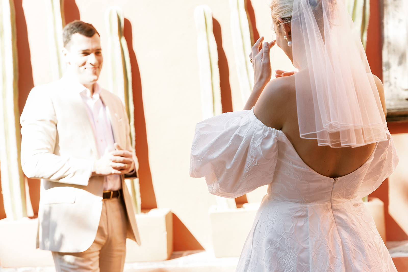 bride cleaning tears as groom admires his bride in casa de Sierra Belmont hotel