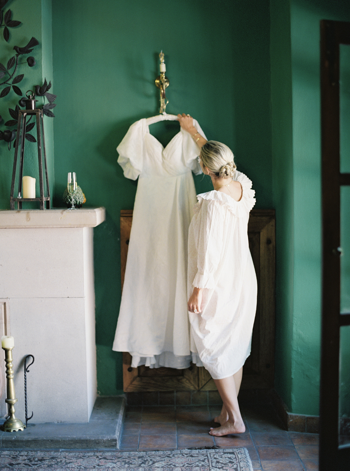 bride grabbing her wedding dress from the hanger before ceremony 