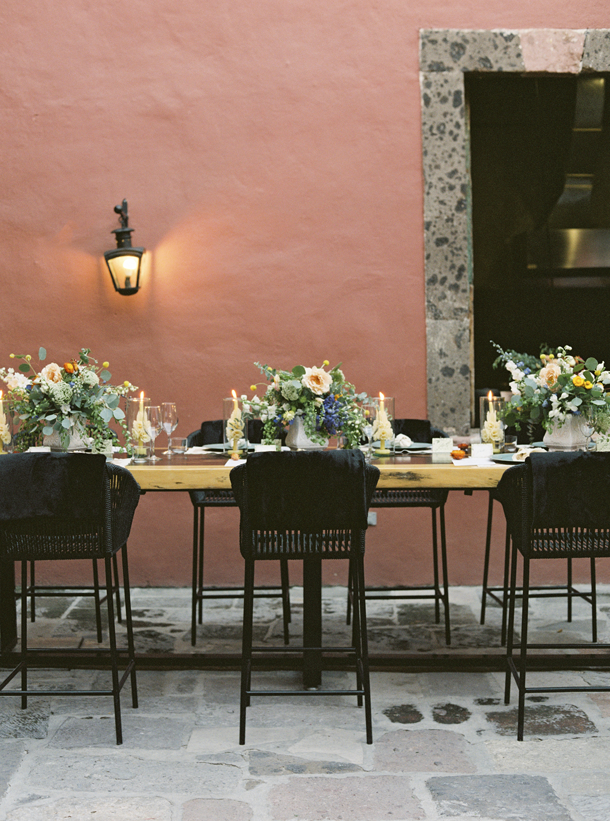 Elegant wedding reception table with floral centerpieces and candles