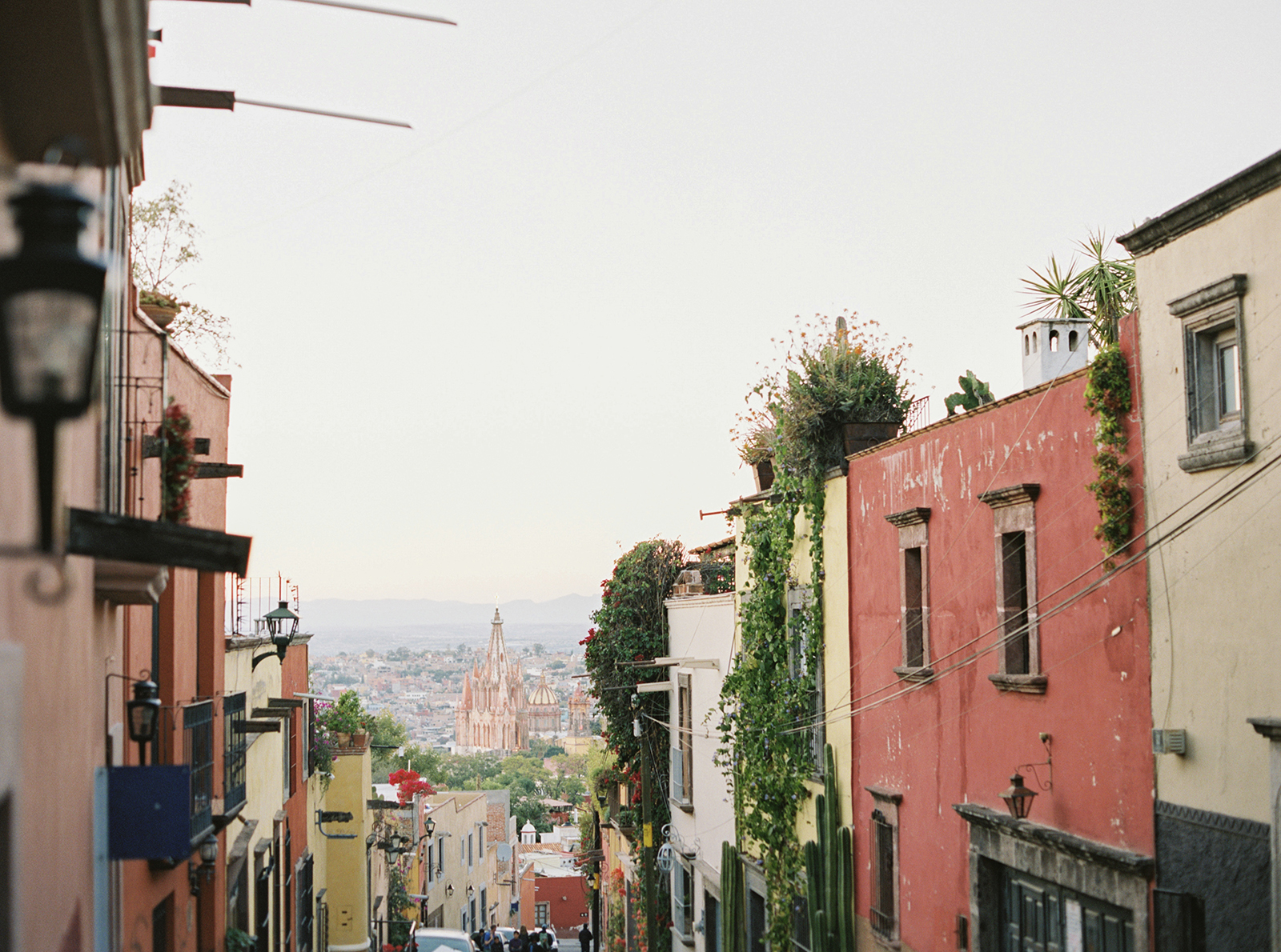 Colorful street scene with layered architecture and city view
