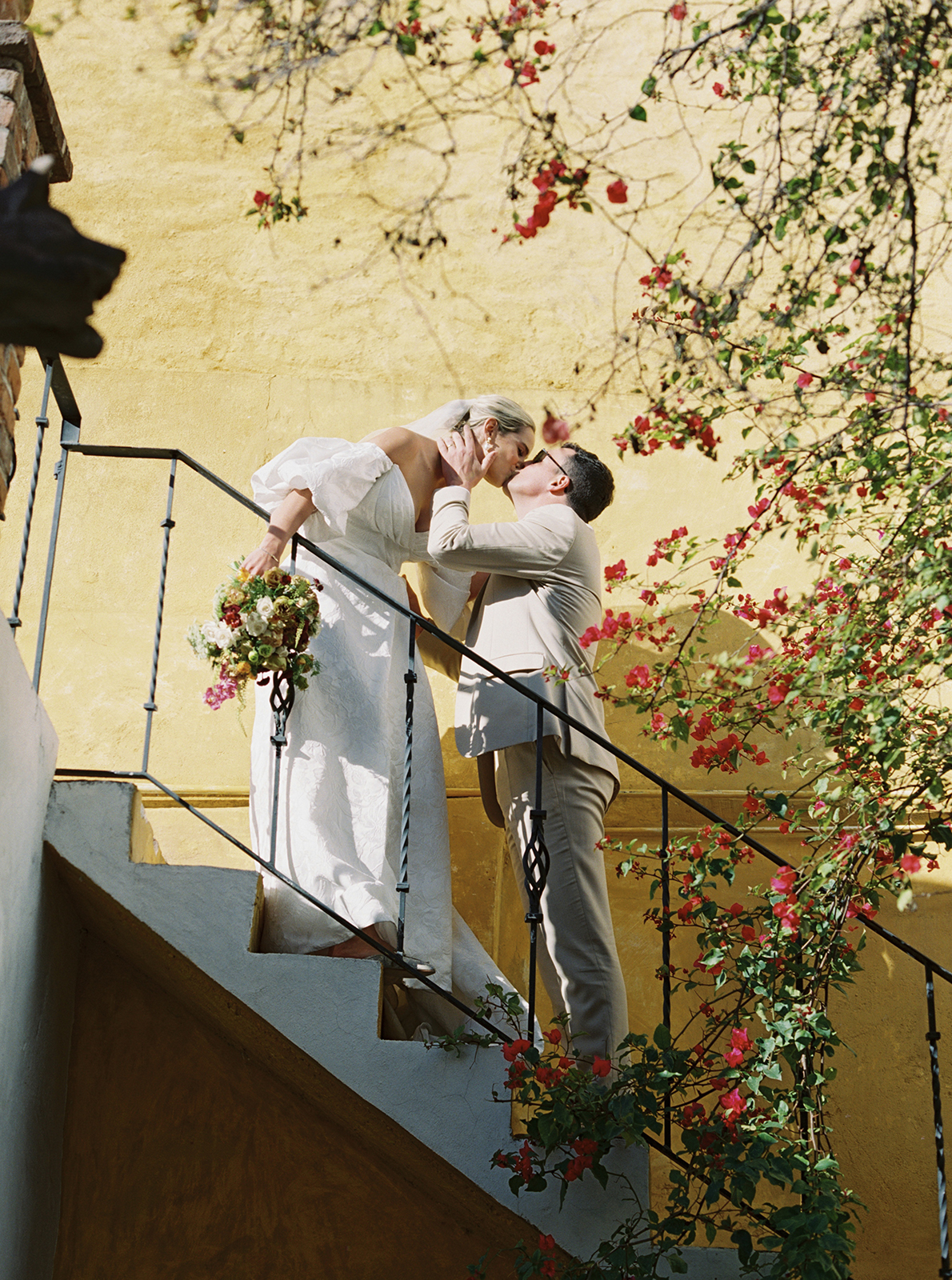 couple kissing on a staircase