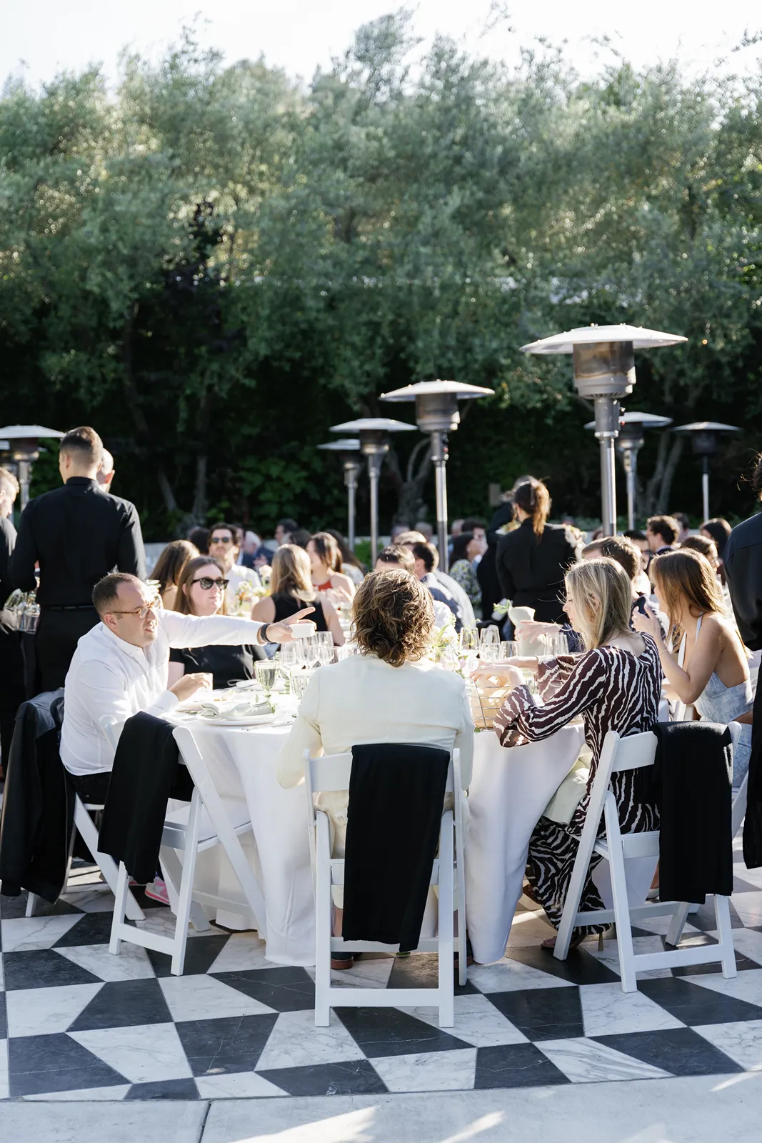 Guests gathered for an outdoor rehearsal dinner in Healdsburg with long tables and evening light