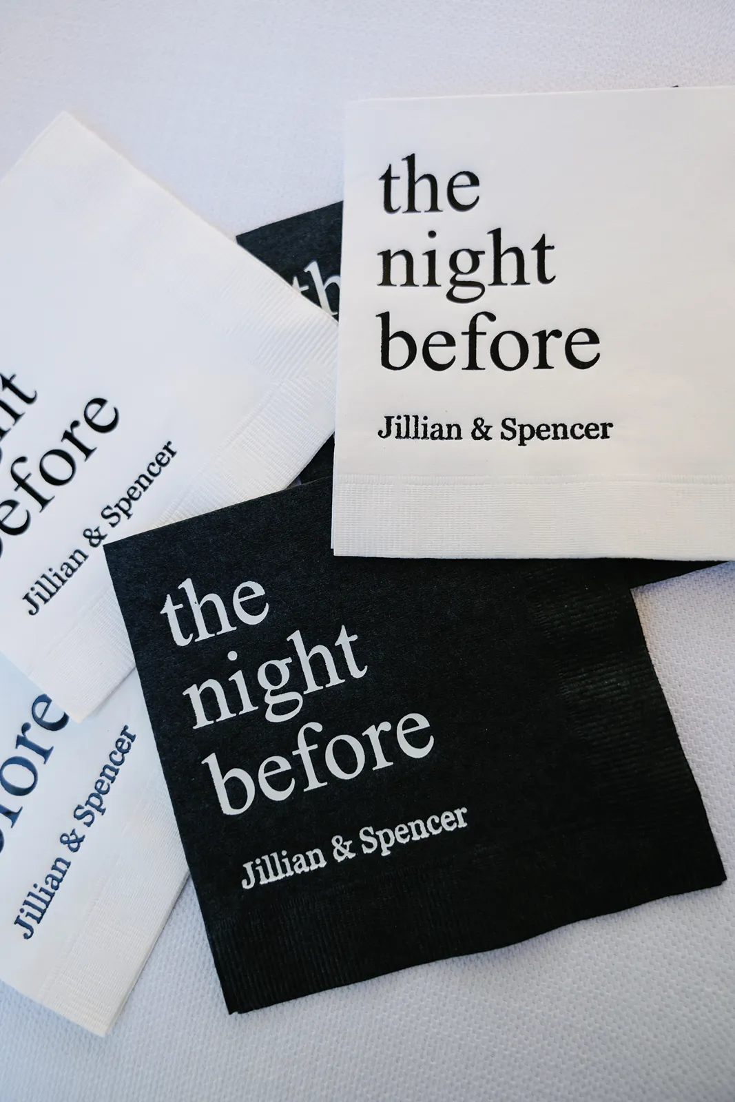 Custom cocktail napkins reading “the night before” displayed on a rehearsal dinner table