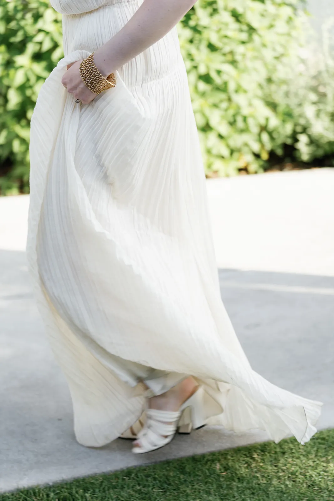 Flowing dress detail as the bride walks during an outdoor rehearsal dinner in Healdsburg