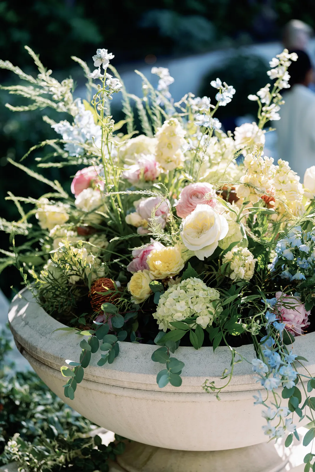 Lush floral arrangement styled in a stone planter at a Sonoma rehearsal dinner