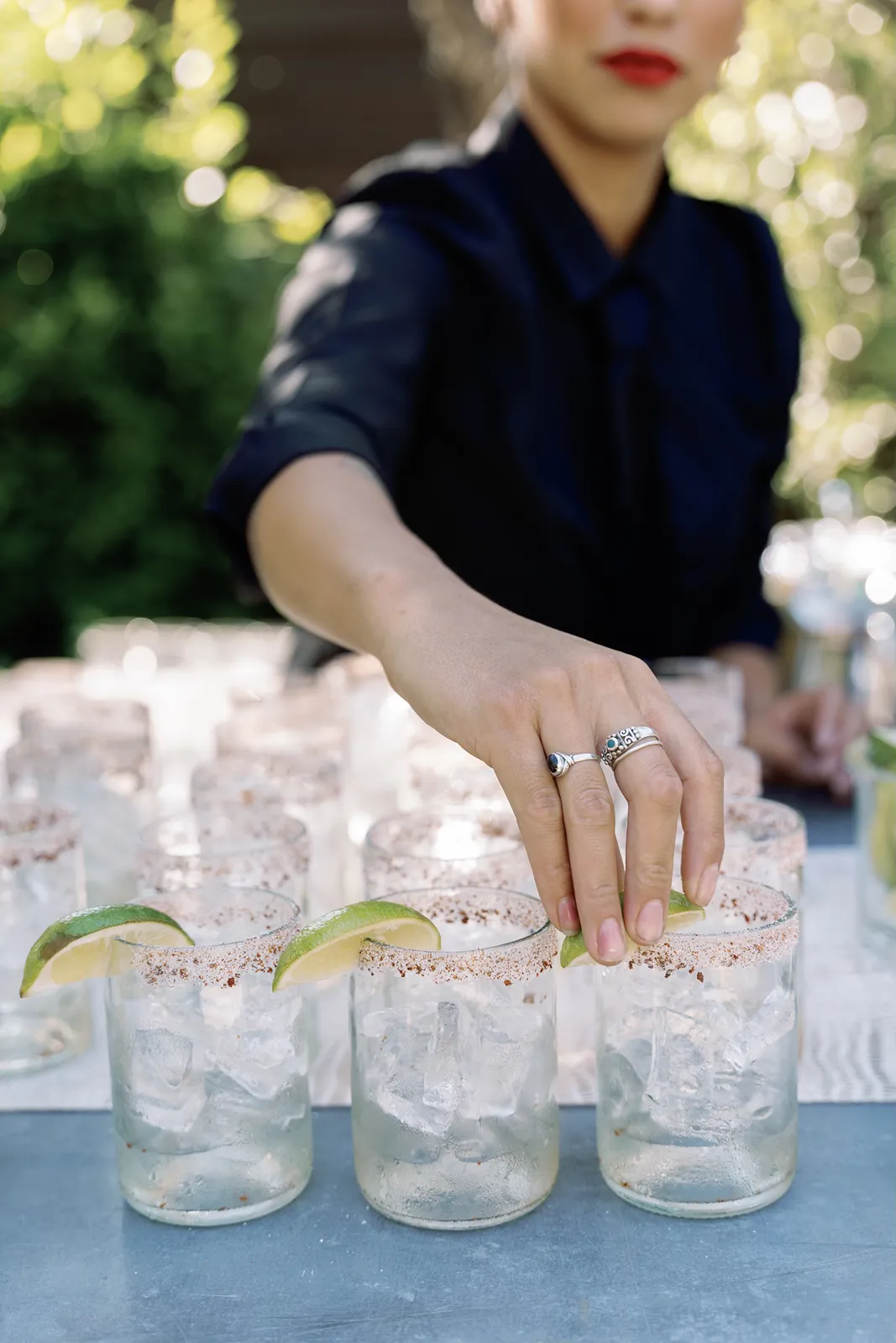Cocktails being garnished with lime wedges during a Sonoma rehearsal dinner cocktail hour