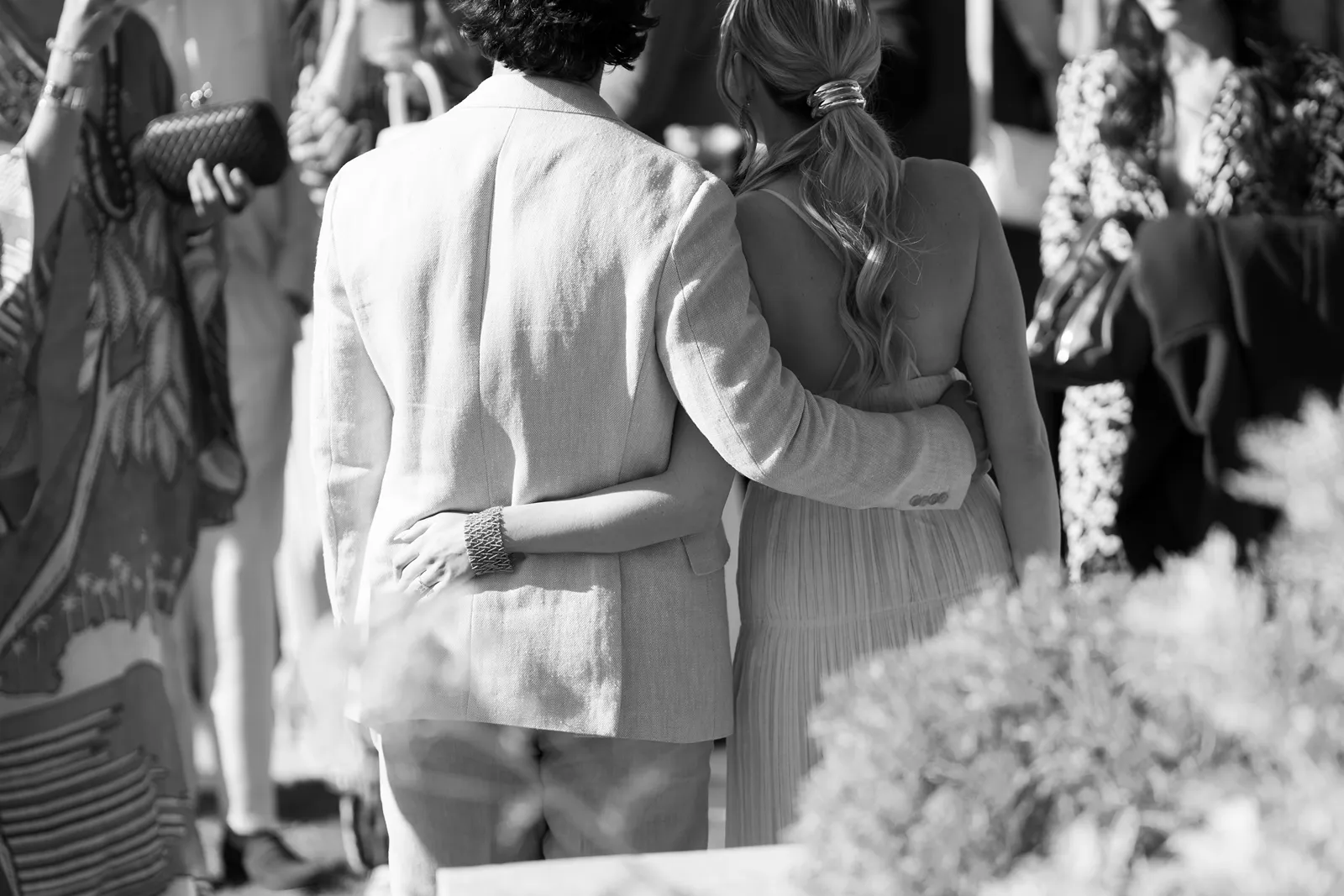 Bride and groom walking arm in arm through guests at a Sonoma rehearsal dinner