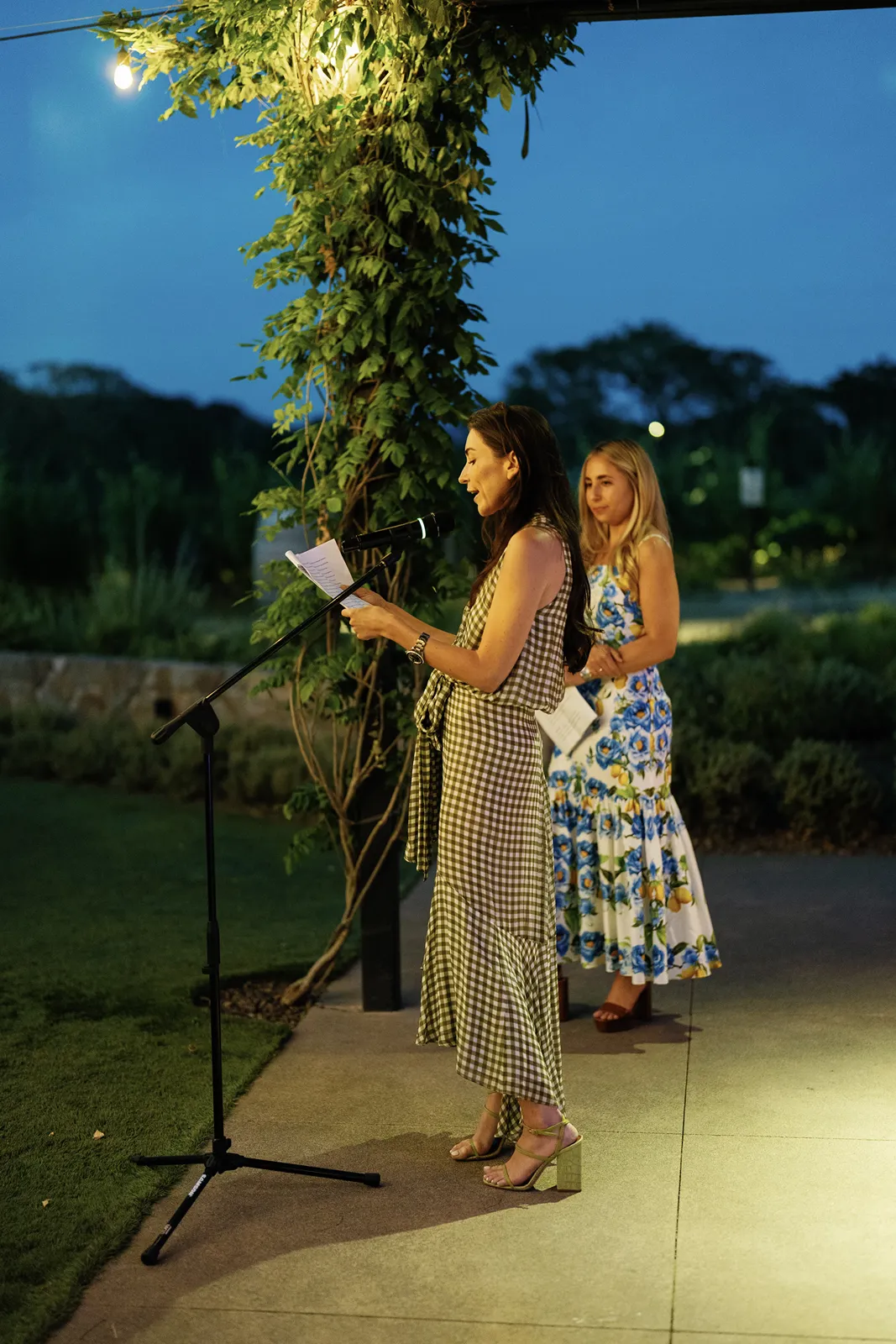 Guest reading a heartfelt speech during an evening Sonoma rehearsal dinner