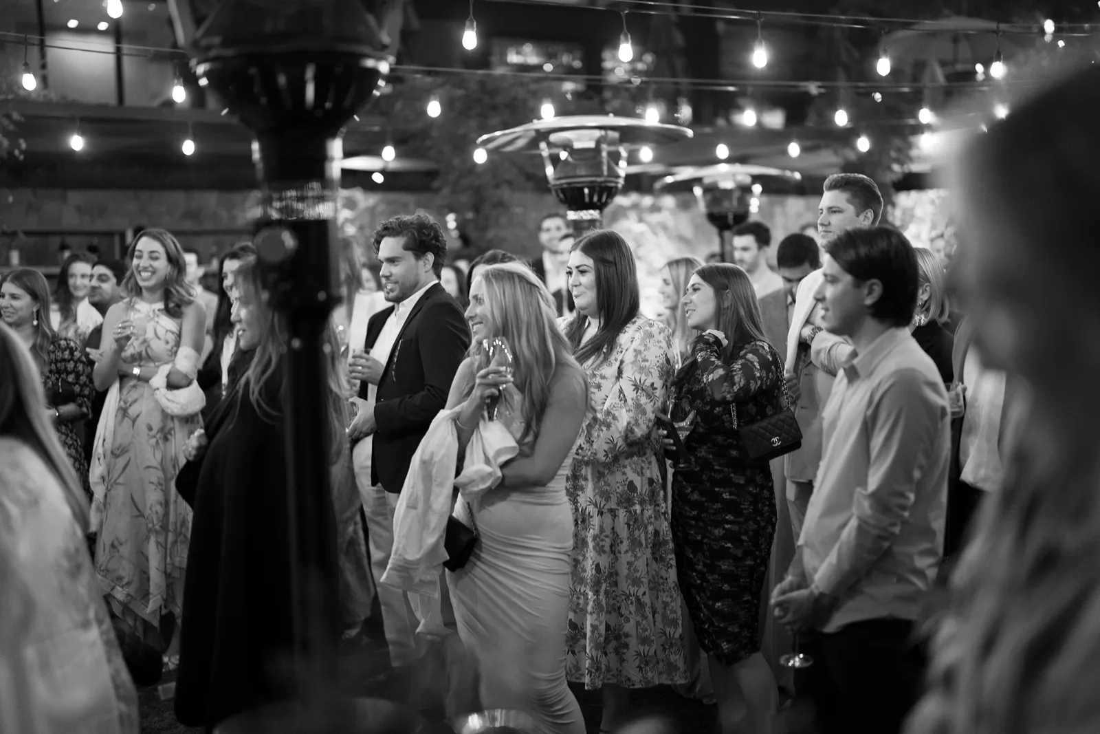 Guests watching speeches and smiling during a Sonoma rehearsal dinner celebration