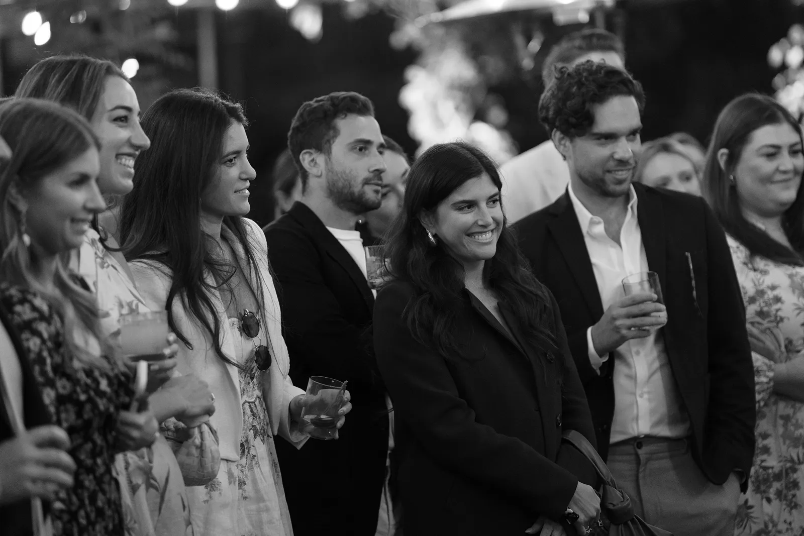 Wedding guests listening and smiling during speeches at a Sonoma rehearsal dinner
