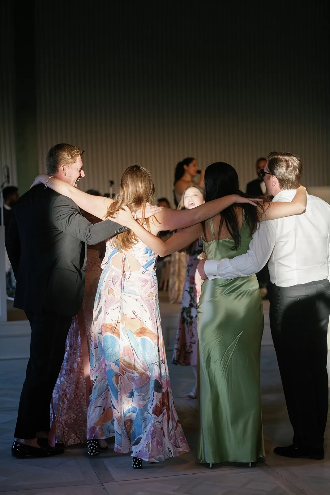 group of four guests dancing with arms on each other