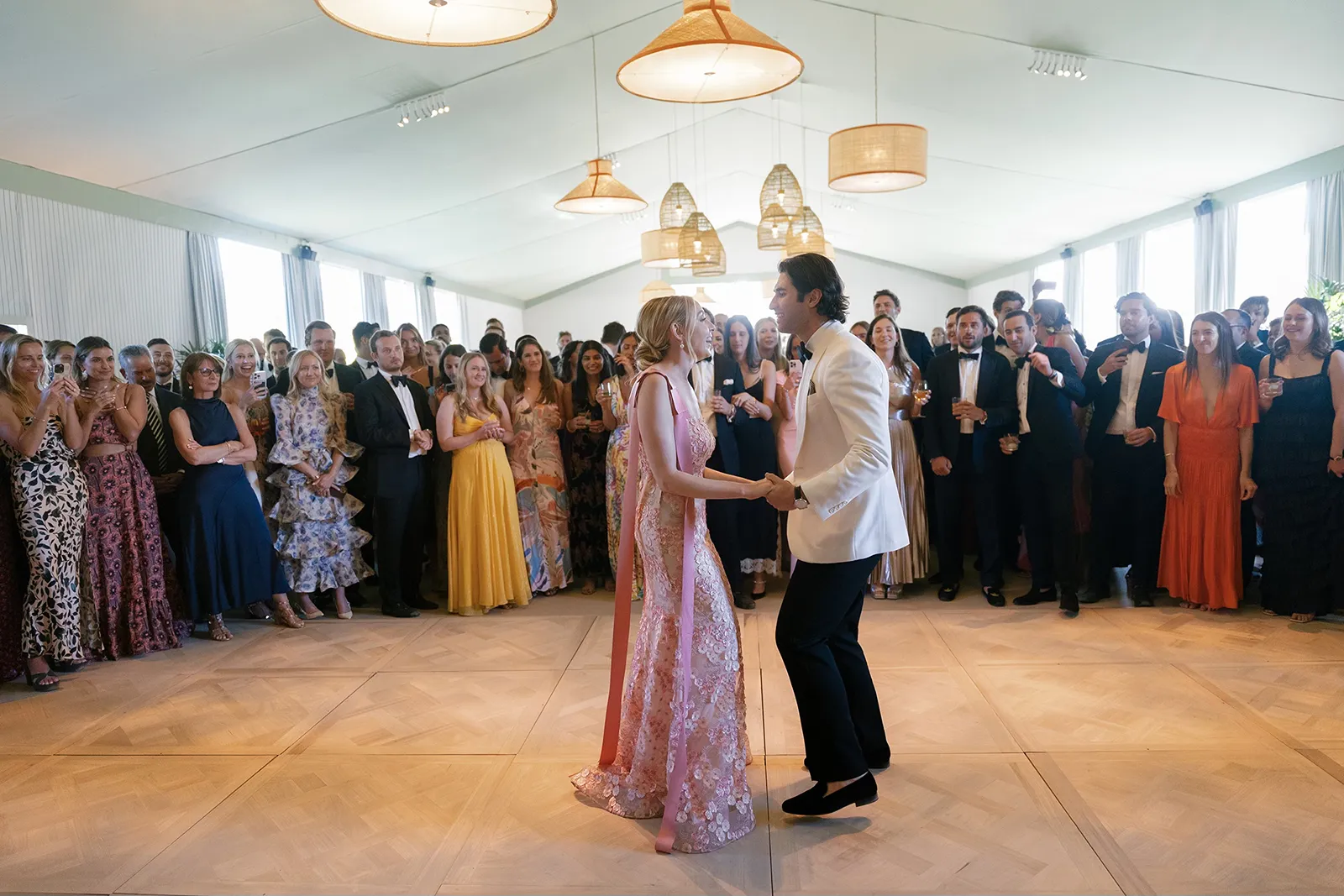 couple during first dance surrounded by guests