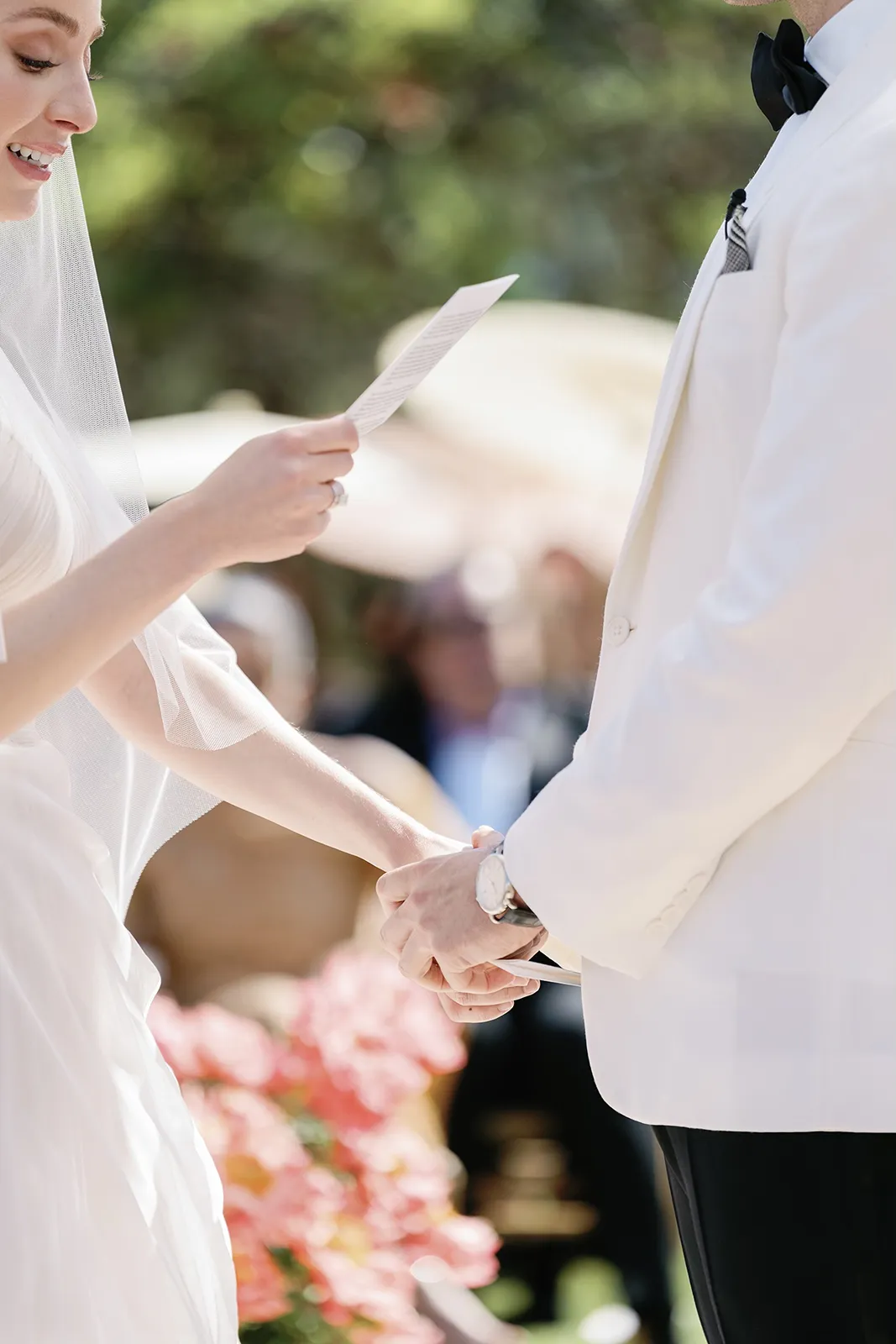 close-up of couple holding hands during wedding vows