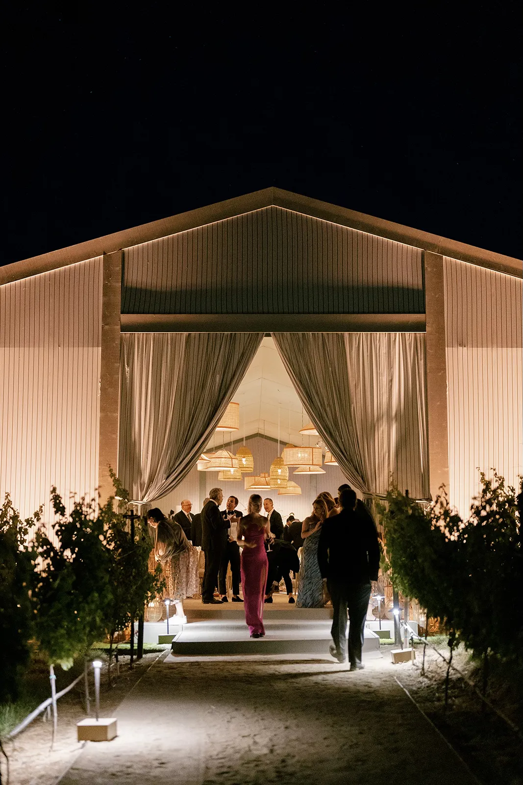 the entrance of the glowing reception tent at night