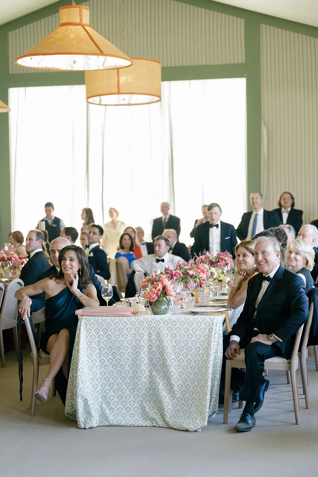 Wedding guests seated at round reception tables with floral centerpieces inside the reception space at Montage Healdsburg