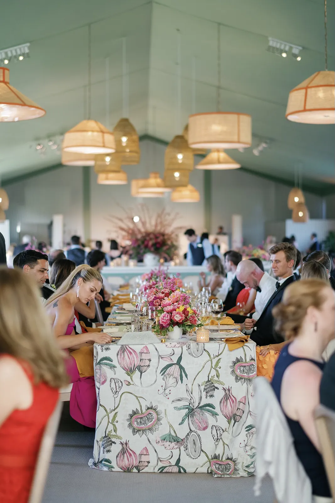 wedding guests seated in dinner tables talking and waiting for the first course