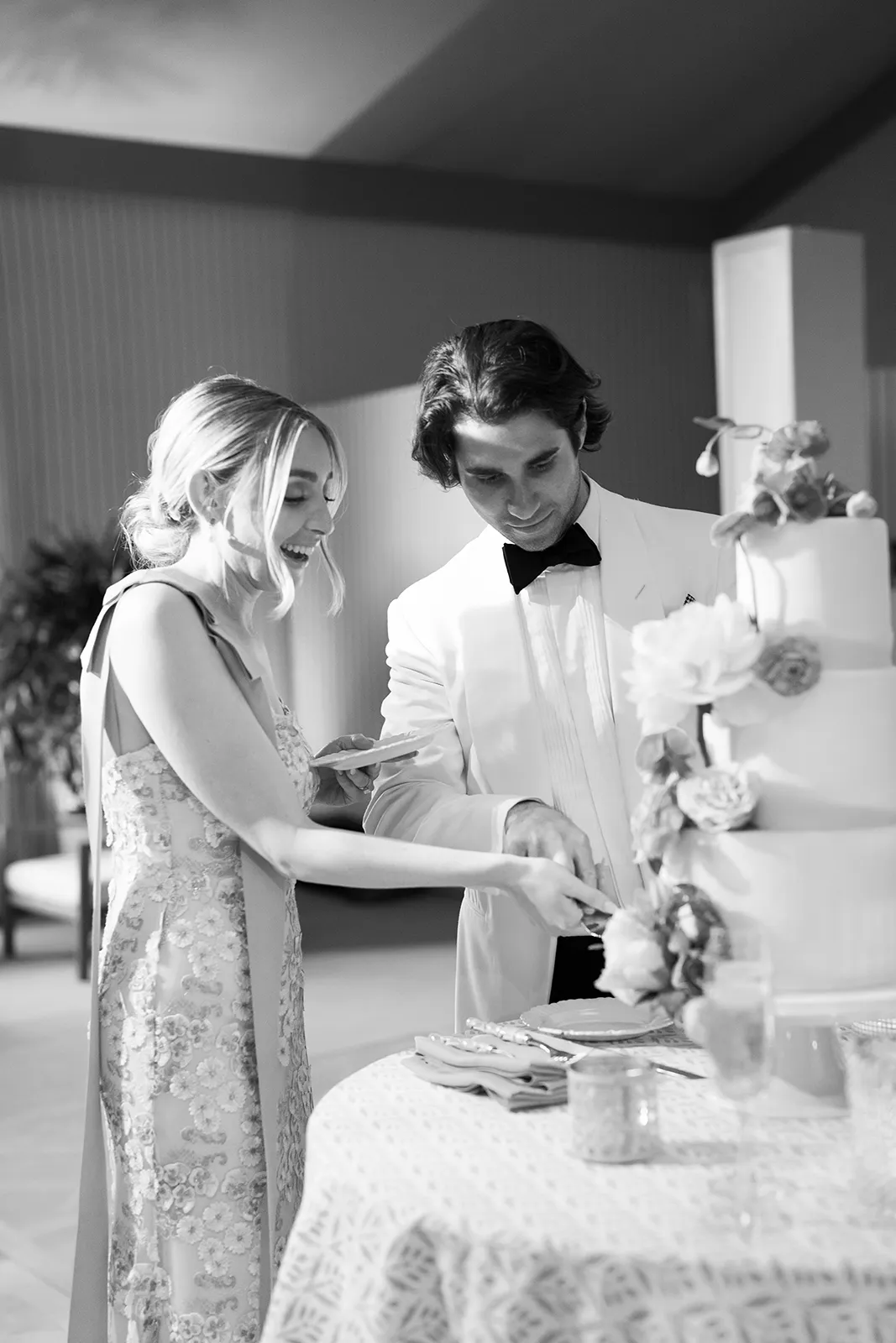 Bride and groom cutting their wedding cake together during reception