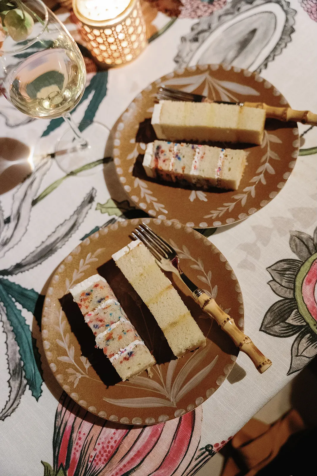 Wedding cake slices served on patterned plates during the reception