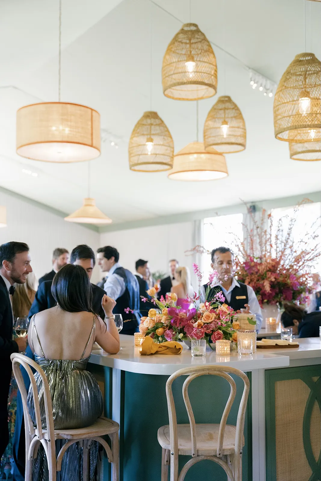 Wedding bar scene with guests mingling beneath woven pendant lights inside Montage Healdsburg