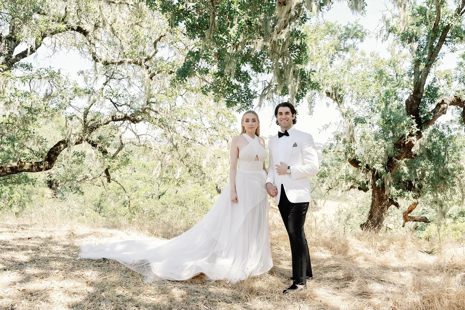 bride and groom under oak trees during bridal portraits