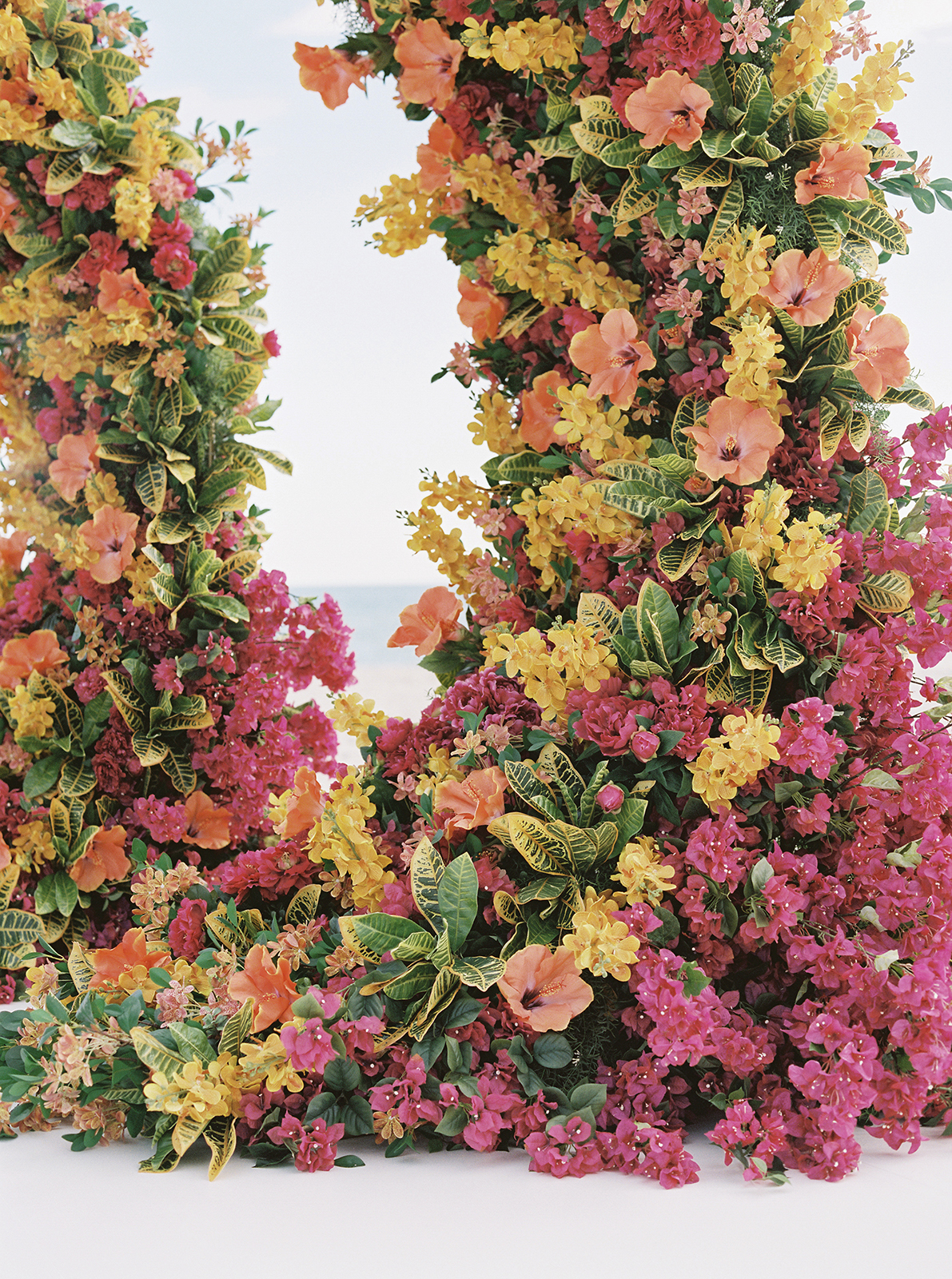 Close-up of colorful floral ceremony arch overlooking the ocean at Faena Hotel Miami Beach wedding