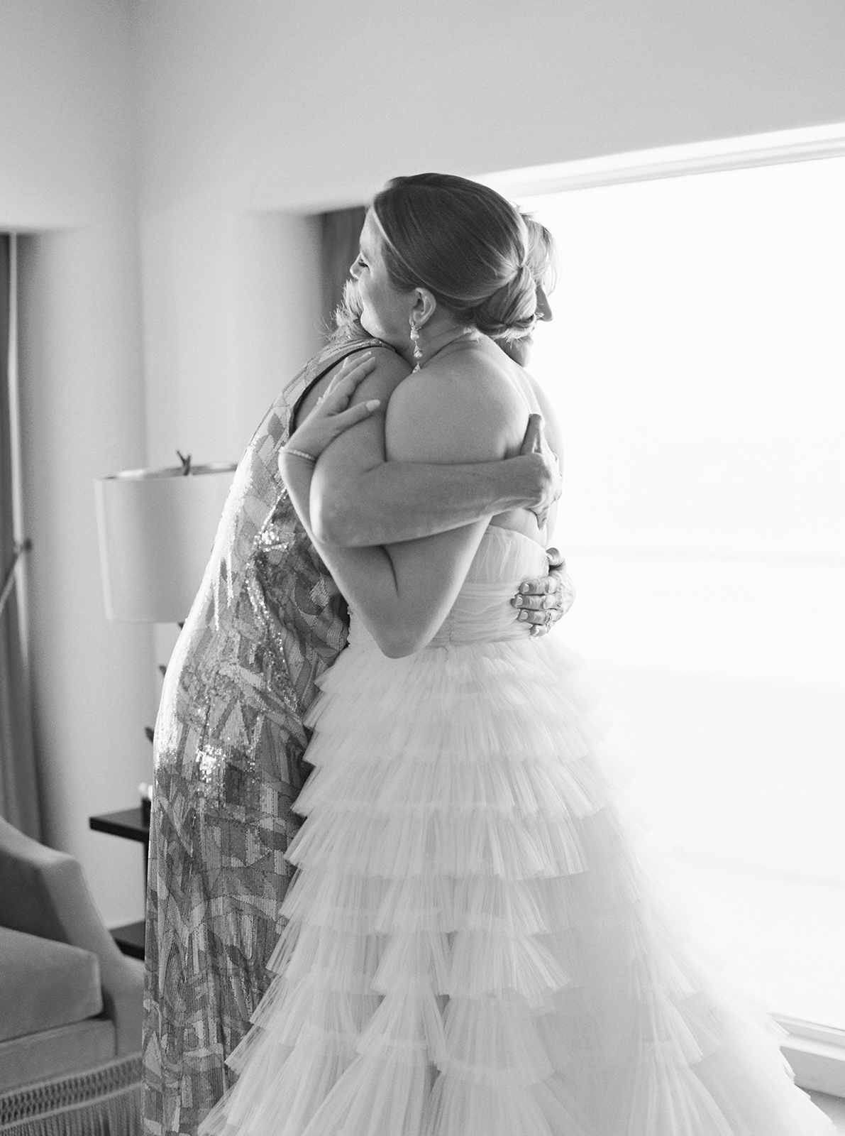 mother of the bride giving a heartfelt hug to bride before wedding