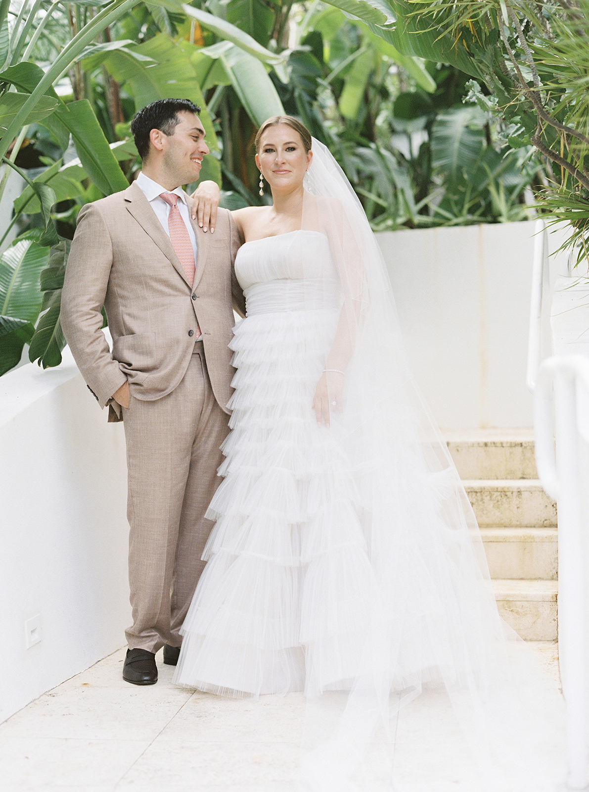 Bride and groom posing together in lush tropical gardens at Faena Hotel Miami Beach