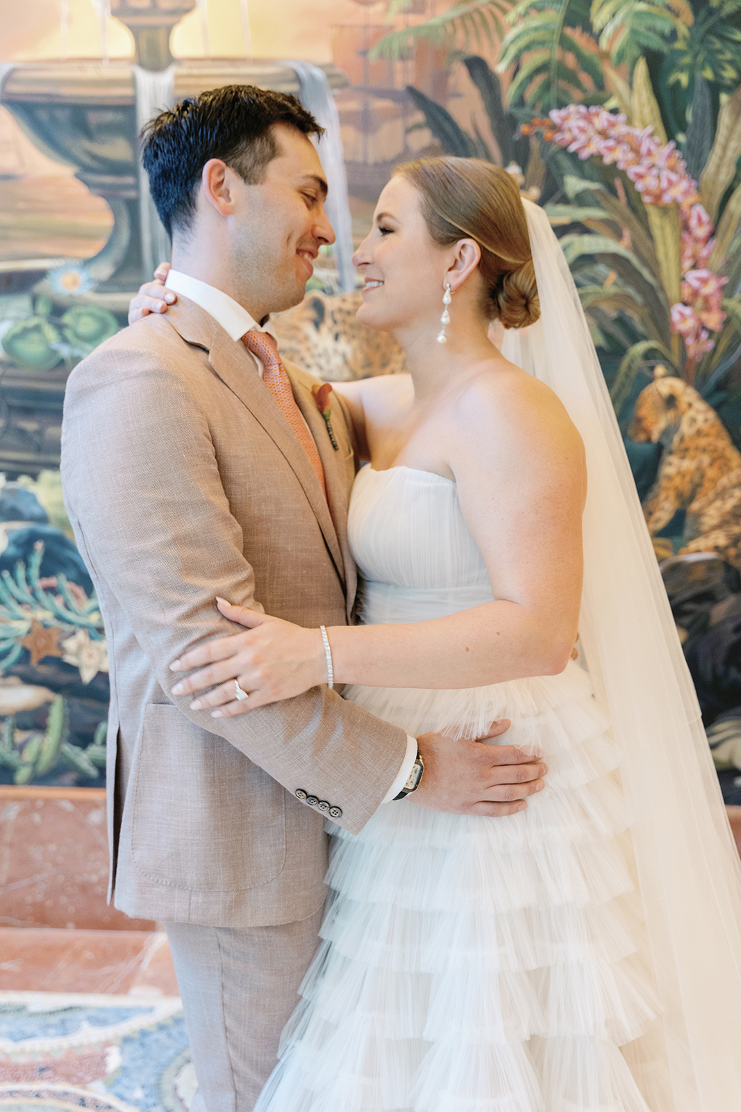 Bride and groom embracing inside Faena Hotel Miami Beach with colorful mural backdrop